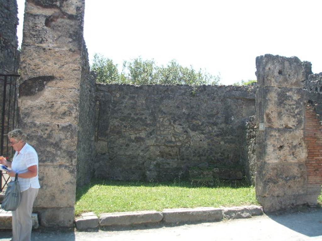 VII.4.52 Pompeii. May 2005. Looking south from entrance across shop.
According to Eschebach, on the left was a small arched niche. On the right at the rear was a staircase to the upper floor with a latrine  beneath.
See Eschebach, L., 1993. Geb�udeverzeichnis und Stadtplan der antiken Stadt Pompeji. K�ln: B�hlau. (p.282)
According to Boyce, in the west wall was a rectangular niche and in the east wall was an arched niche. One of them was probably a Lararium.
See Boyce G. K., 1937. Corpus of the Lararia of Pompeii. Rome: MAAR 14. (p.66, no.280) 

Graffito was found in April 1833 on the pilaster on the right, between VII.4.52 and 53 �
Rufum  d(ignum?)  [�]
L(ucium)  Nu[mis]iu[m
De[�]      [CIL IV 287]
See Pagano, M. and Prisciandaro, R., 2006. Studio sulle provenienze degli oggetti rinvenuti negli scavi borbonici del regno di Napoli. Naples : Nicola Longobardi. (p.147)
