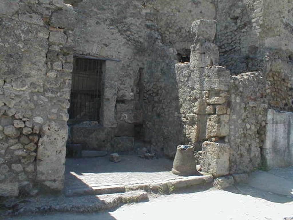 VII.4.63 Pompeii. May 2005.  Entrance, with downpipe from upper floor latrine in rear south-west corner, on right. On the right, in front of the downpipe, would have been the stairs to the upper floor. In the south wall was a window looking into VII.4.62.
See Eschebach, L., 1993. Geb�udeverzeichnis und Stadtplan der antiken Stadt Pompeji. K�ln: B�hlau. (p.285)
