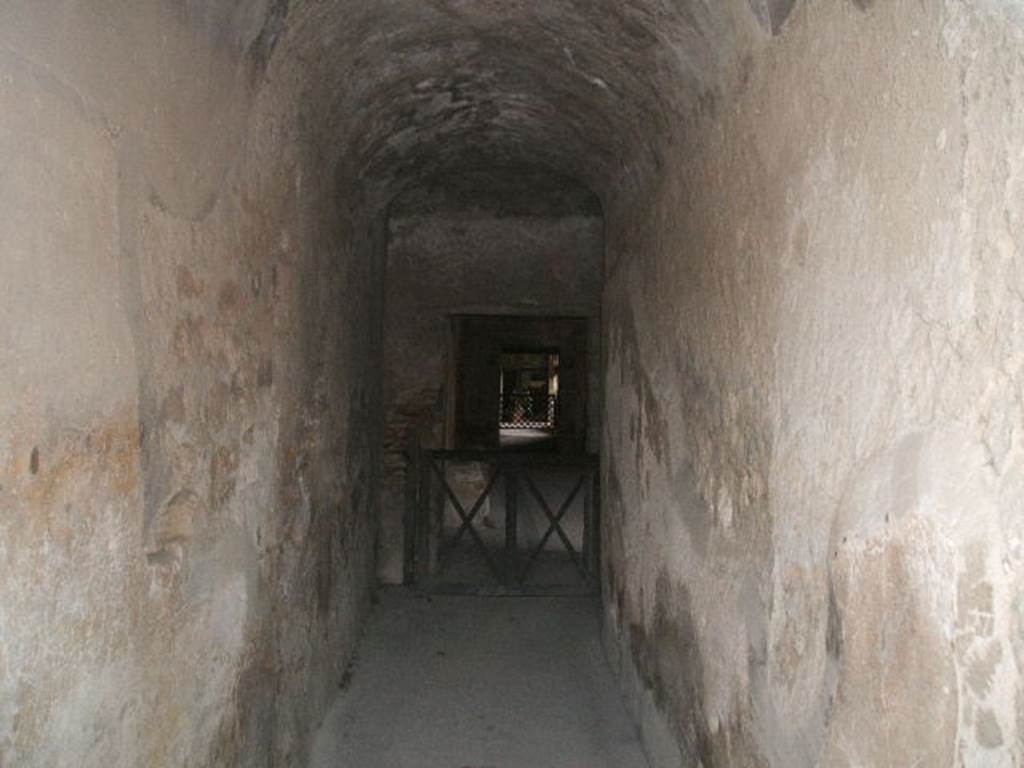 VII.5.2 Pompeii. May 2005. Looking south along corridor (16) into men�s baths and changing room (14).
According to Fiorelli �
This corridor would have led directly into the changing room (apodyterium), consisting of a large room with seating on three sides (14).
