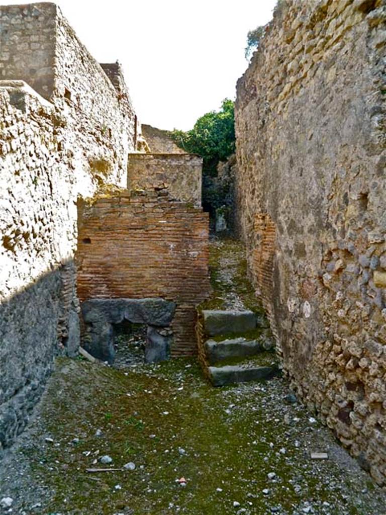 VII.5.7 Pompeii. May 2011. Looking south from entrance (26)  across the furnace room (25). Remains of praefurnium front (27) between the men�s and women�s baths. Photo courtesy of Michael Binns.