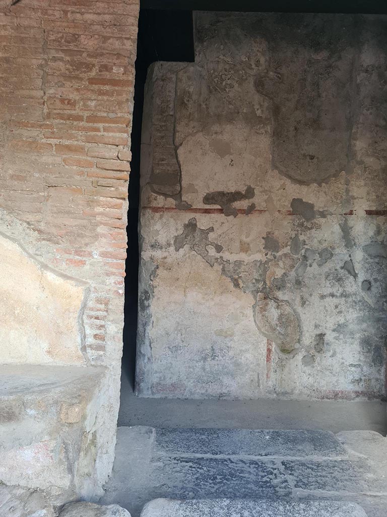 VII.5.8 Pompeii. October 2024. 
Looking towards south side from entrance doorway with bench, on left, and doorway to corridor (45), centre left. 
Photo courtesy of Klaus Heese.

