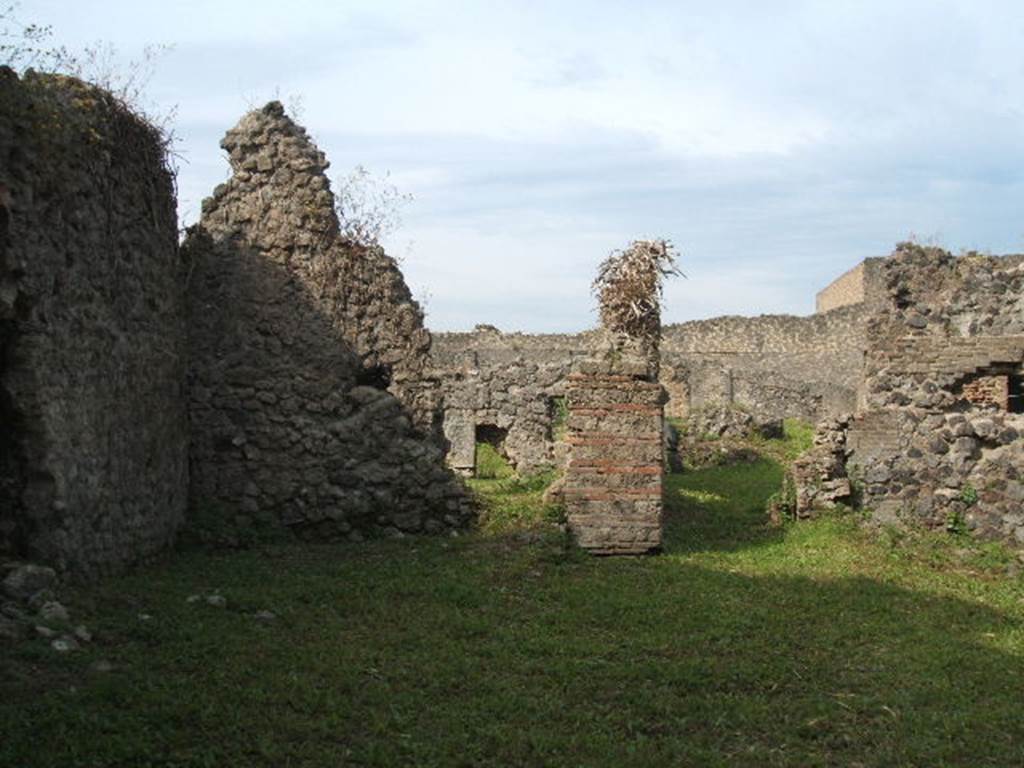 VII.6.16 Pompeii. May 2005. Looking west to site of rear room (on left) and corridor leading to VII.6.11 (on right). Only the south and west walls of the rear room survive.
