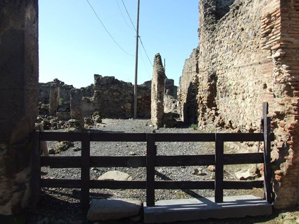VII.6.19 Pompeii. March 2009. Looking west across workshop to rear.
According to Garcia y Garcia, this was very devastated and ruined following the September 1943 bombing, together with VII.6.20.
See Garcia y Garcia, L., 2006. Danni di guerra a Pompei. Rome: L�Erma di Bretschneider. (p.102). 
According to Della Corte, because of the considerable quantities of colouring materials and pigments found here, he considered it the workshop of an unknown and unnamed Negotiator Pigmentarius.
See Della Corte, M., 1965.  Case ed Abitanti di Pompei. Napoli: Fausto Fiorentino. (p.173)
