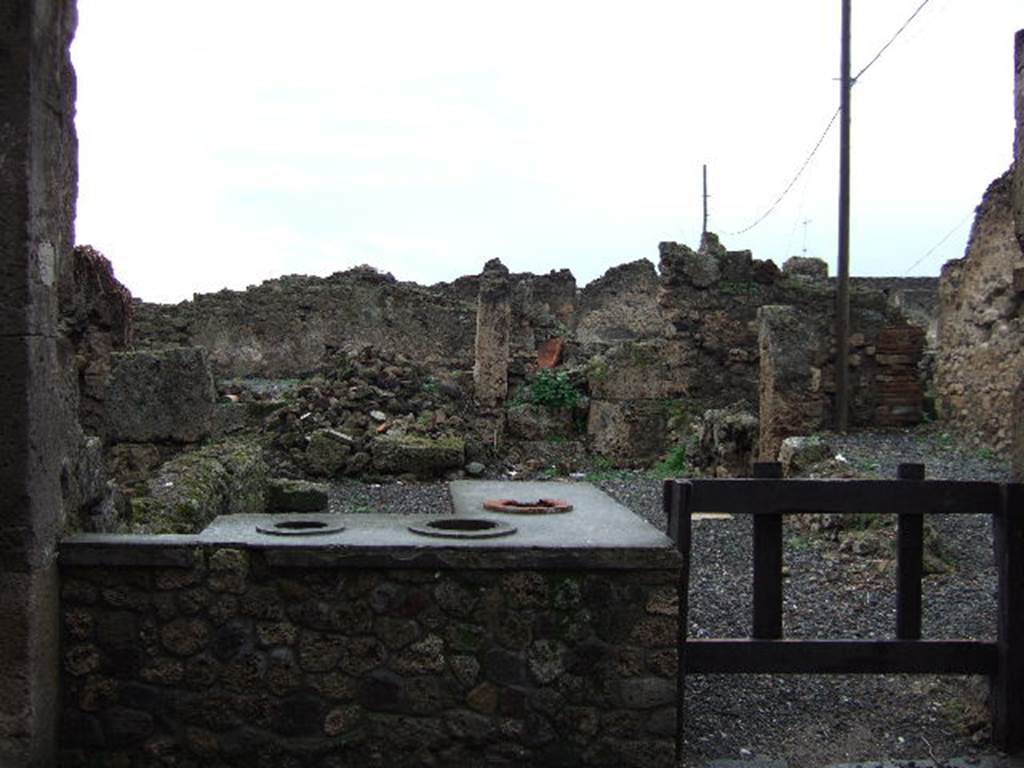 VII.6.20 Pompeii. December 2004. Two sided counter with 3 urns and a hearth.