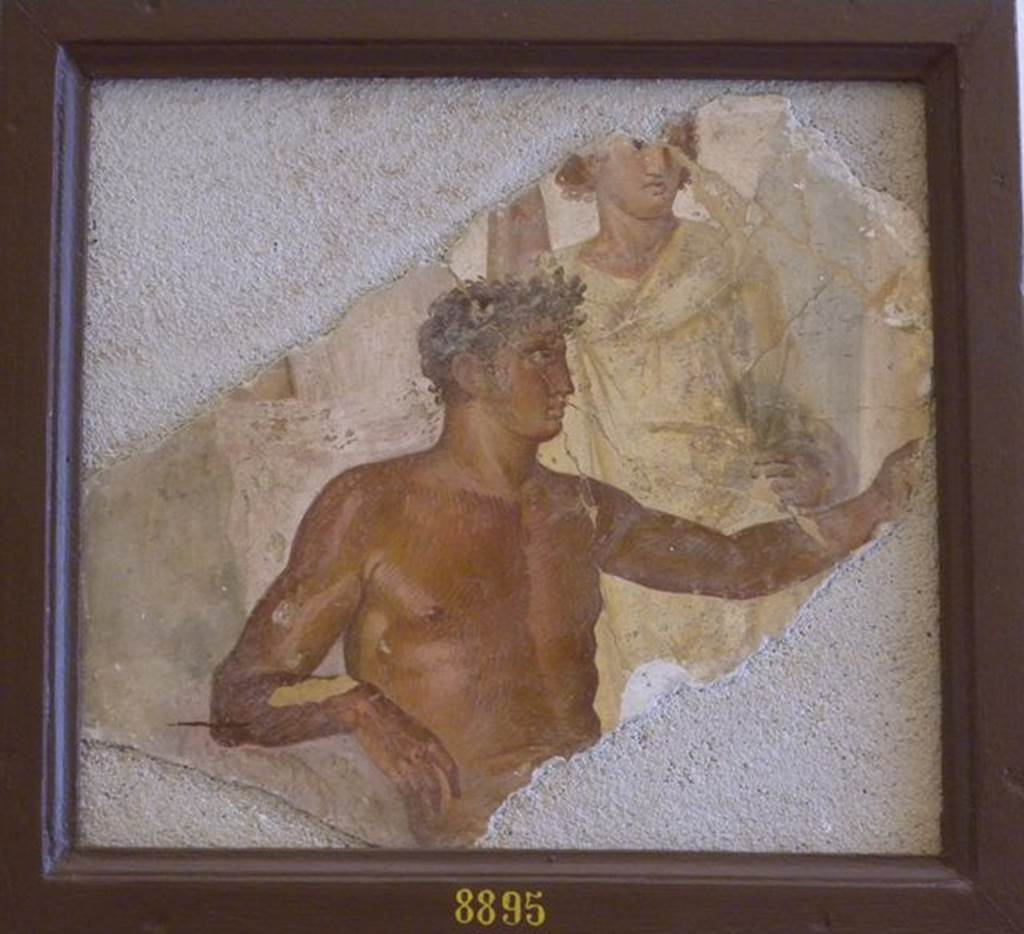 VII.6.28 Pompeii. Found 10th April 1762 in cubiculum 8.  Fragment of a wall painting with two figures. One is a naked man with a crown of leaves, possibly Apollo. See Helbig, W., 1868. Wandgemälde der vom Vesuv verschütteten Städte Campaniens. Leipzig: Breitkopf und Härtel. (1167).
See Pagano, M., and Prisciandaro, R., 2006. Studio sulle provenienze degli oggetti rinvenuti negli scavi borbonici del regno di Napoli.  Naples : Nicola Longobardi.  (p.41). Now in Naples Archaeological Museum.  Inventory number 8895.
