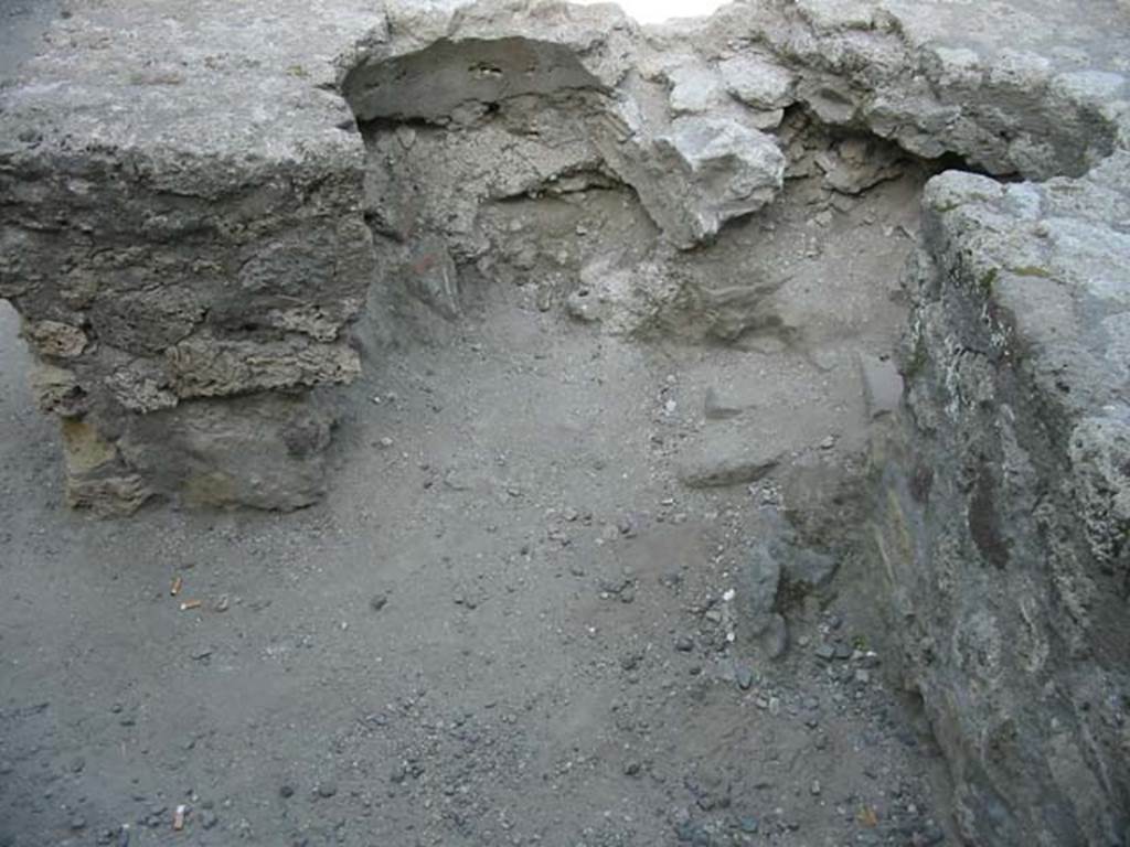 VII.7.9 Pompeii. May 2003. Looking towards rear of two-sided counter, where there would have been two dolia embedded into the counter.  Photo courtesy of Nicolas Monteix.
