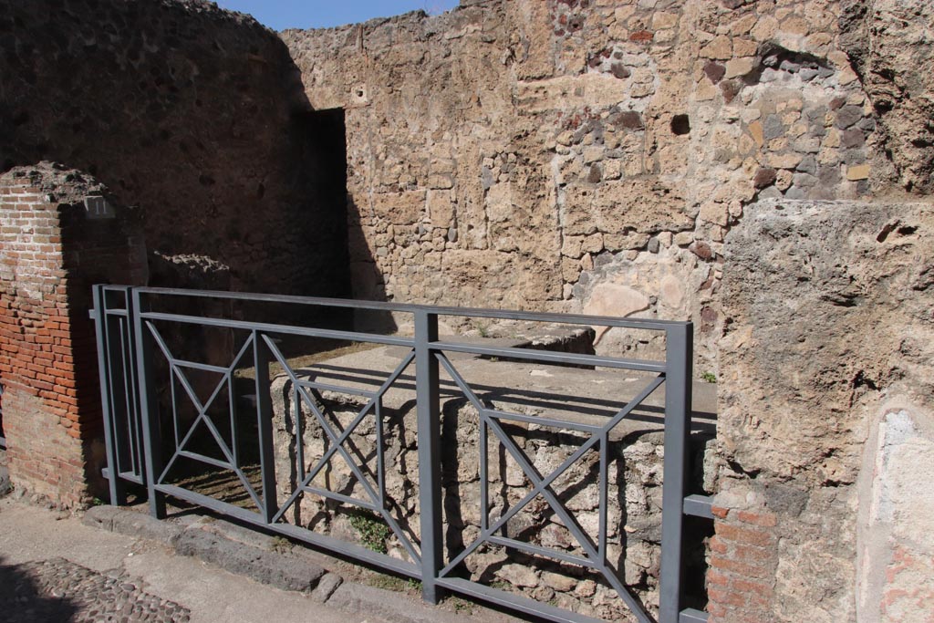 VII.7.11 Pompeii. October 2023. Looking north-west across shop towards doorway to rear. Photo courtesy of Klaus Heese.