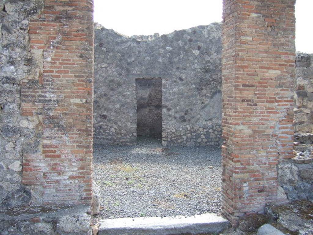 VII.7.21 Pompeii. September 2005. Looking south across atrium towards doorway to small enclosed tablinum. According to Garcia y Garcia, the bombardment caused the destruction of he walls of two rooms, with the loss of painted plaster. 
See Garcia y Garcia, L., 2006. Danni di guerra a Pompei. Rome: L�Erma di Bretschneider. (p.116)
