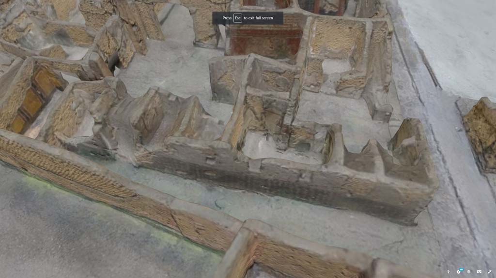 VII.7.21, Pompeii. October 2017. Detail from model in Naples Archaeological Museum.
Looking west in small alley/vicolo towards side wall of VII.7.21, leading to doorway of VII.7.23, centre left. 
The Zebra Stripe decoration can be seen along the wall. 
Information and Foto from Taylor Lauritsen, ERC Grant 681269 D�COR.
