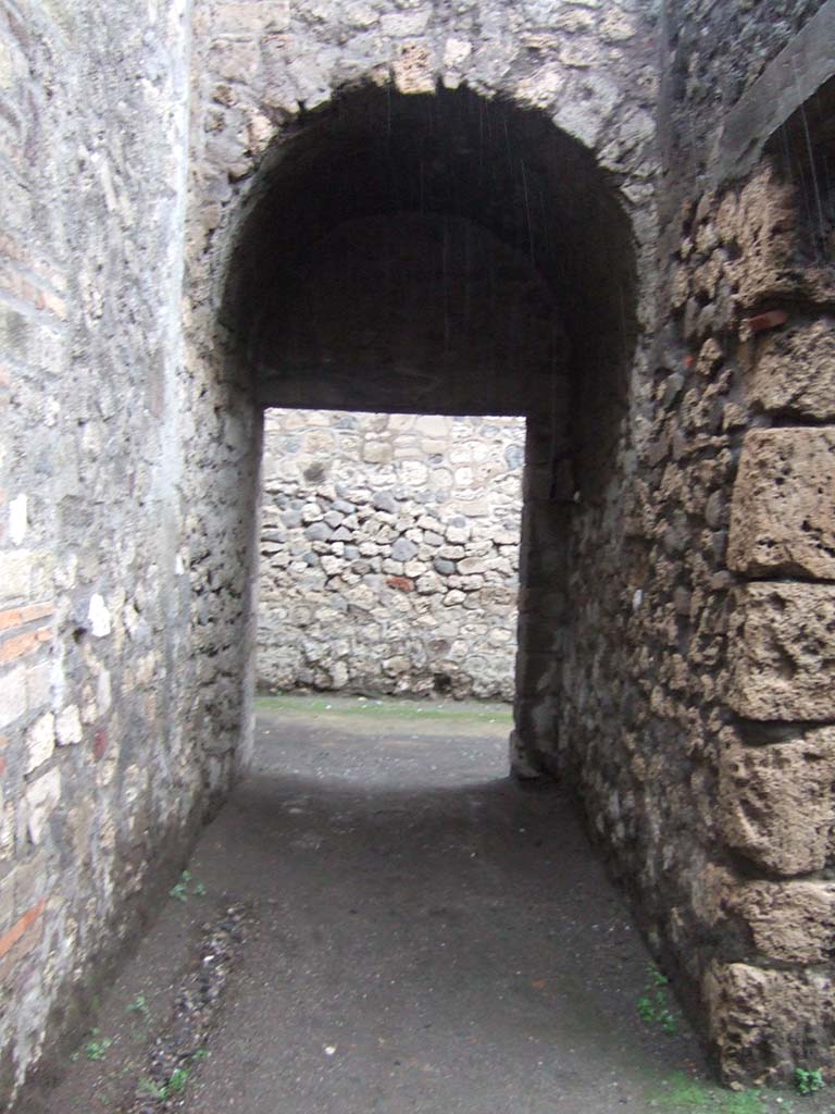 VII.7.30 Pompeii. December 2005. Passage behind steps from Temple of Apollo. to corridor leading west from entrance at VII.7.30.
In this area would have been a room destined perhaps for the use of the Priests of the Temple, where the painting of Bacchus and Silenus was found.
