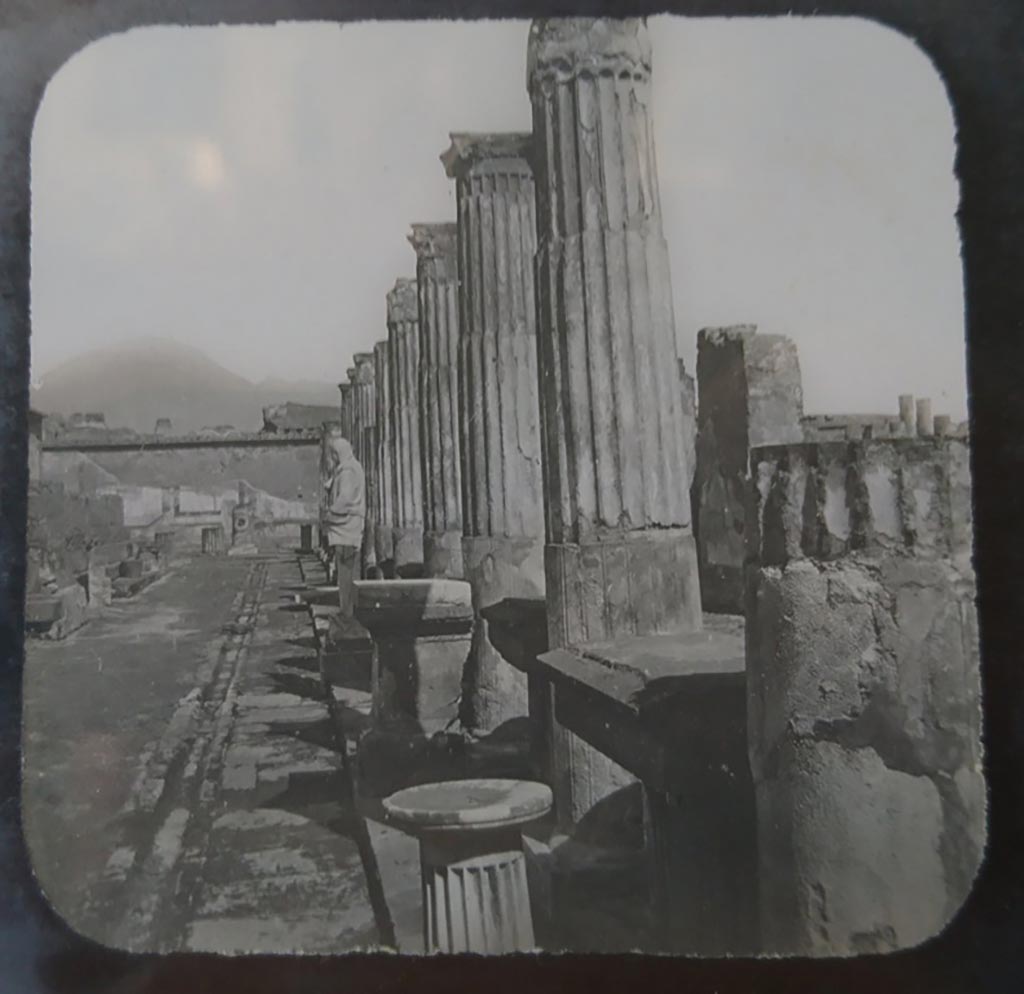 VII.7.32 Pompeii. c.1900. C. and G. Lantern slide published by A. Laverne. 
Looking north along east portico towards north wall, still with painted decoration. The Forum is on the right.   
