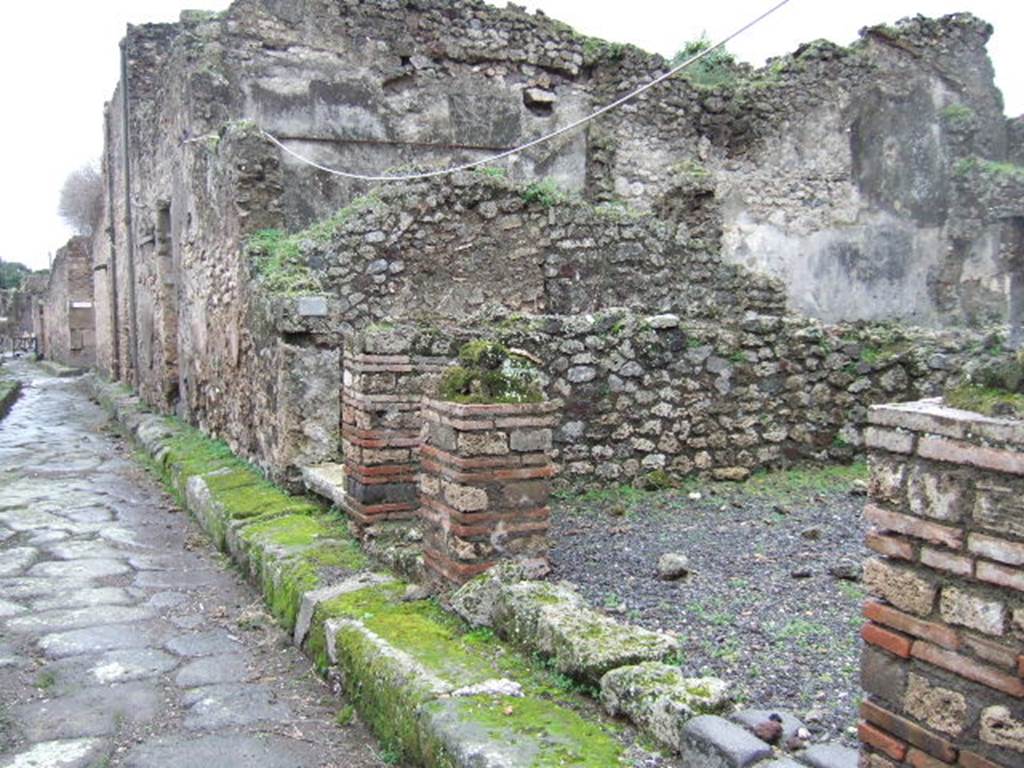 Pompeii. December 2005. VII.10.11 (steps to upper floor) and VII.10.10 (shop doorway).

