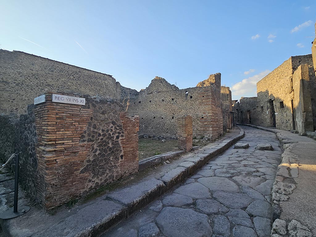 VII.11.17 and 16 Pompeii. November 2024. 
Looking towards entrance doorways on west side of Vicolo del Lupanare. Photo courtesy of Annette Haug.
