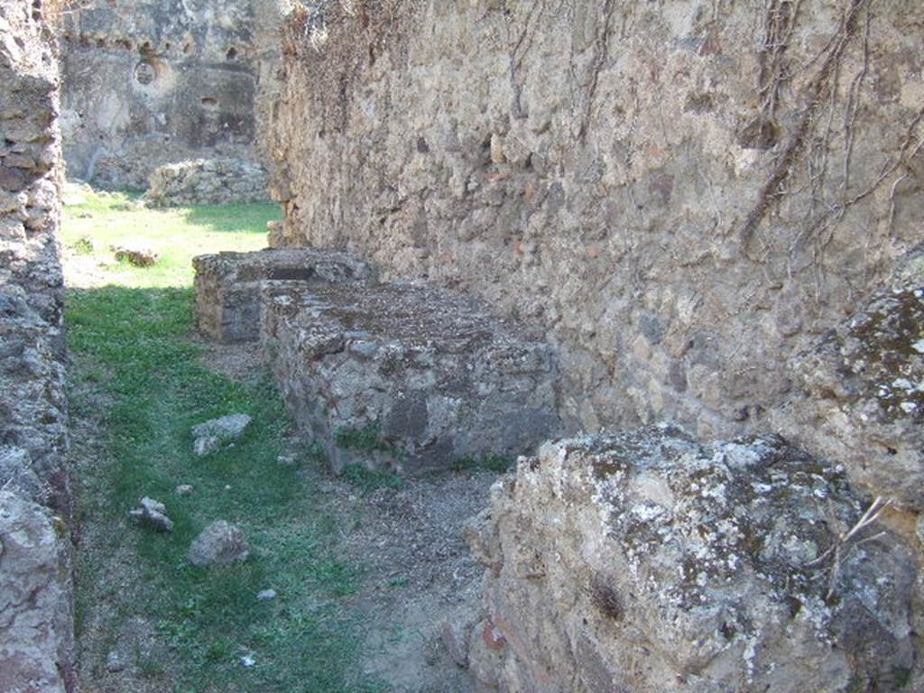 VII.12.13 Pompeii.  September 2005.  Corridor to bakery area.  West wall with podiums.