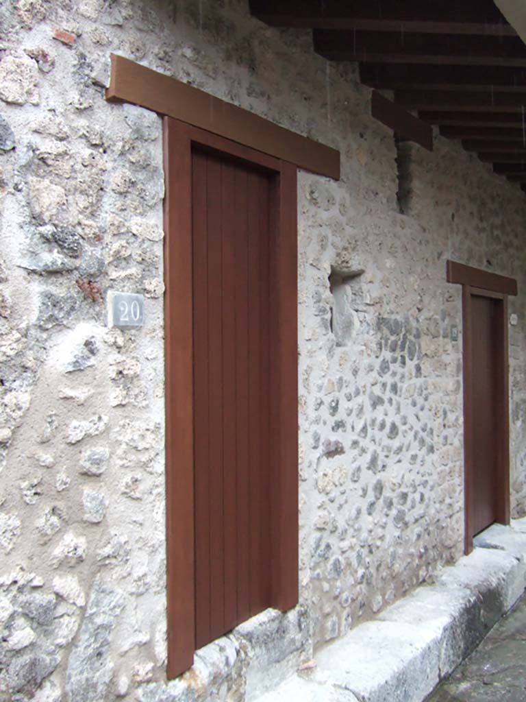 VII.12.20 Pompeii. December 2005. Entrance doorway. This doorway had a bell. 
The top floor was reached by a staircase.  This led to a corridor which gave access to five more small rooms.  
These were in addition to the five rooms below in the Lupanare at VII.12.18 and VII.12.19.  

