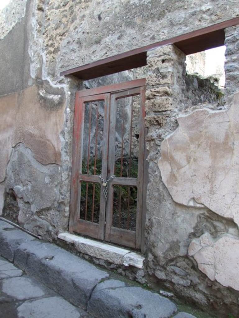 VII.12.23 Pompeii. December 2007. Plaster on street wall on both sides of entrance.