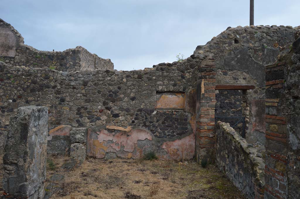 VII.15.12 Pompeii. March 2018. Looking east across room described as “central atrium-like room” or triclinium.
Foto Taylor Lauritsen, ERC Grant 681269 DÉCOR.
 According to Boyce, in the east wall of the central atrium-like room was a shallow, rectangular niche of unusual proportions.
Its walls were coated with yellow stucco and decorated with red stripes; the Bull. Inst. referred to it as “forse un larario”.
See Bullettino dell’Instituto di Corrispondenza Archeologica (DAIR), 1874, 71.
See Boyce G. K., 1937. Corpus of the Lararia of Pompeii. Rome: MAAR 14. (p.72, no.333).



