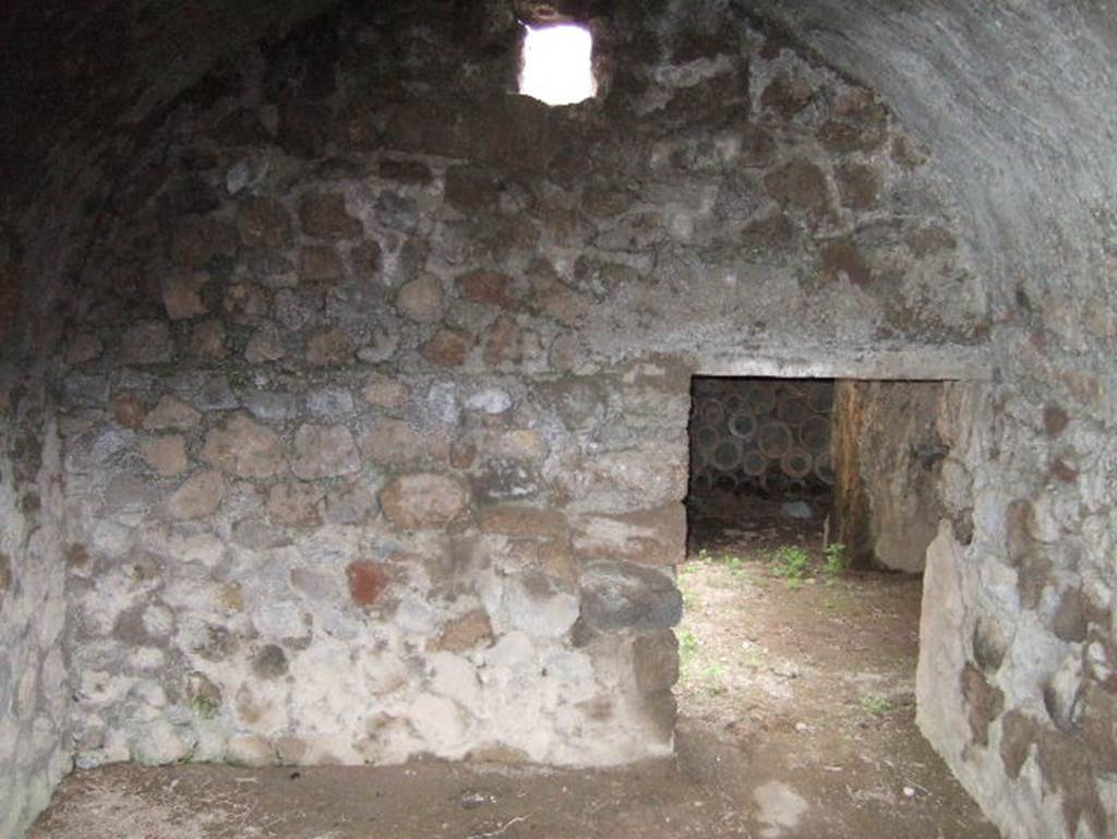 VII.15.16 Pompeii. May 2006. Room D, looking towards east wall with doorway to corridor.
On the opposite side of the corridor is the doorway into room E.  
