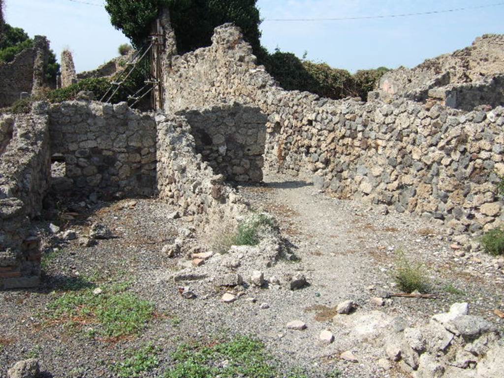 VII.16.9 Pompeii, on left, and side room, perhaps storeroom on right. September 2005.
According to Eschebach, this was a two-roomed bakery, with an oven at the rear.
On the right may have been stairs to the upper floor.
See Eschebach, L., 1993. Geb�udeverzeichnis und Stadtplan der antiken Stadt Pompeji. K�ln: B�hlau. (p.347)
According to Garcia y Garcia, this bakery was totally destroyed in the 1943 bombardment.
The oven has now disappeared.
See Garcia y Garcia, L., 2006. Danni di guerra a Pompei. Rome: L�Erma di Bretschneider. (p.131)

