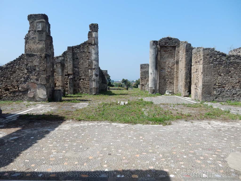 VII.16.13 Pompeii. June 2019. Looking west across atrium 2, towards tablinum 9. Photo courtesy of Buzz Ferebee.  
According to Fiorelli –
“Il tablino, che sta di fronte allo ingresso, tiene ai lati due oeci, i cui aditi dall’atrio furono anticamente murati:e succede ad esso un grandioso peristilio, contenente un’ampia piscina, con piu stanze nei lati, e con spaziosi loggiati che si prolungavano sulle pubbliche mura.”
See Pappalardo, U., 2001. La Descrizione di Pompei per Giuseppe Fiorelli (1875). Napoli: Massa Editore. (p.161).
(translation: “"The tablinum which stands facing the entrance doorway, had two reception rooms (oeci) on its sides, whose doorways to the atrium were formerly walled up in antiquity: and following on was a large peristyle containing a large pool, with several rooms at the sides, and with spacious loggias that extended onto the public walls.")
