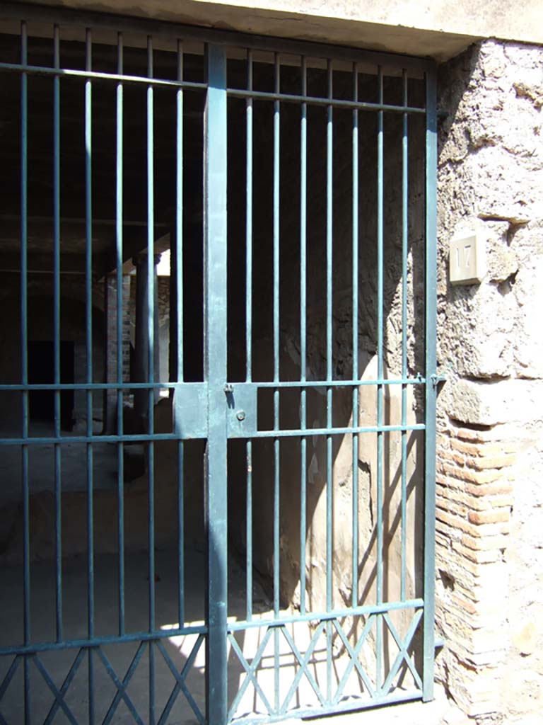 VII.16.17 Pompeii. September 2005. Entrance doorway on Vicolo dei Soprastanti.
According to Jashemski, the rooms of the complex of Fabius Rufus, which included this House of Maius Castricius, are on different levels.
The rooms on the east along Vicolo del Farmacista were on street level.
Those on the south, entered from Vicolo del Soprastanti, were on the floor below.
See Jashemski, W. F., 1993. The Gardens of Pompeii, Volume II: Appendices. New York: Caratzas. (p.202)

According to Garcia y Garcia, prior to the 1943 bombing, on the right side of this doorway, was another numbered 17A.
All of the perimeter wall between entrances 17 and 19, on the north side of Vicolo dei Soprastanti, was demolished by the bombing for a length of at least 20 metres.
Also lost was a small window with metal grating which was on the right side of 17A.
Following the damage from the bombardment in 1943, and the restoration and cleaning which followed in October 1960, changes were made.
See Garcia y Garcia, L., 2006. Danni di guerra a Pompei. Rome: L’Erma di Bretschneider. (p.137 and figs. 327-8)

According to Varriale, the name Maius Castricius was derived from an Oscan inscription [Eituns] found on the south-east corner of VII.6.
This directed soldiers to follow the road that ran inside the walls and passed the houses of Maius Castricius and Mara Spurnus.  [CTP shows these as VII.16.17 and VII.16.13].
Whilst the actual ownership cannot be verified, the inscription does provide evidence that houses existed overlooking the walls in Samnite times.
See Varriale I., VII 16, Insula Occidentalis, 17, Casa di Maius Castricius in Aoyagi M., Pappalardo U., 2006. Pompei (Regiones VI-VII) Insula Occidentalis. Napoli: Valtrend, p 421.
