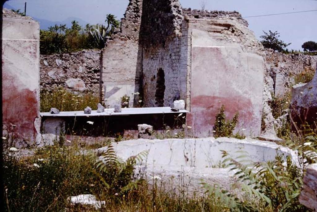 VII.16.22 Pompeii. 1964. Looking north-east across circular pool which would have had a fountain jet and would have been painted blue, through the window of the large room,. 
At the rear of the large room, the north wall of the atrium can be seen.  Photo by Stanley A. Jashemski.
Source: The Wilhelmina and Stanley A. Jashemski archive in the University of Maryland Library, Special Collections (See collection page) and made available under the Creative Commons Attribution-Non Commercial License v.4. See Licence and use details.
J64f2025
