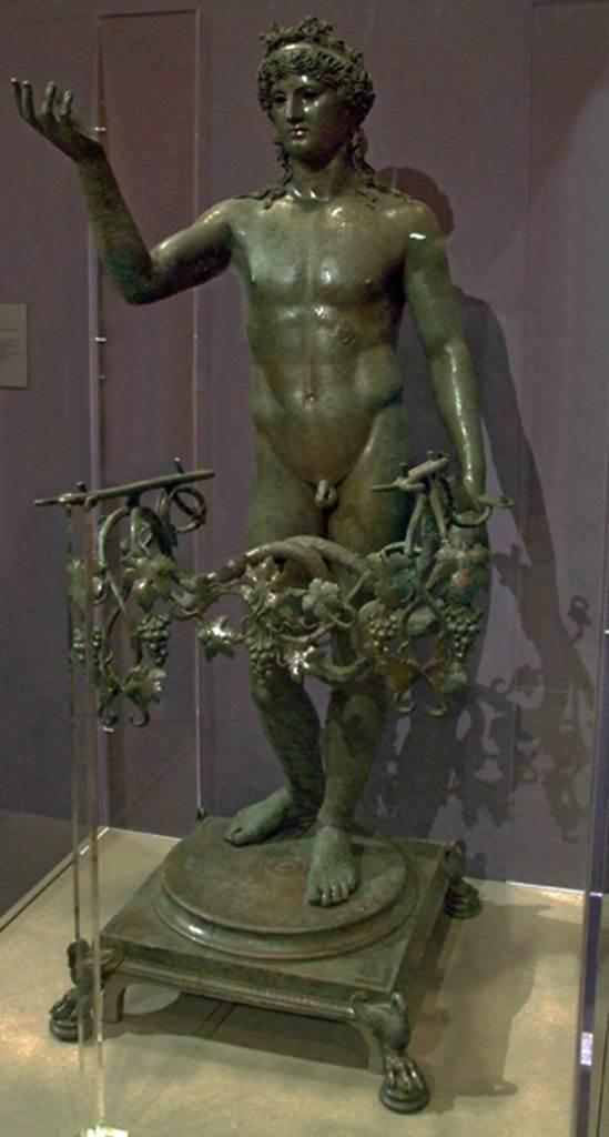 VII.16.17-22 Pompeii. Found 20th December 1960 near the “grande salone del casa”. 
Statue of an Ephebus made into a lamp.
Now in Naples Archaeological Museum.  Inventory number 13112.
See Sodo, A. M. (2005): Cibo e Luxus: in Cibi e Sapori a Pompei e dintorni, p. 52, fig. 17.
See Conticello, B., Ed, 1990. Rediscovering Pompeii. Rome: L’Erma di Bretschneider. (p. 257).
