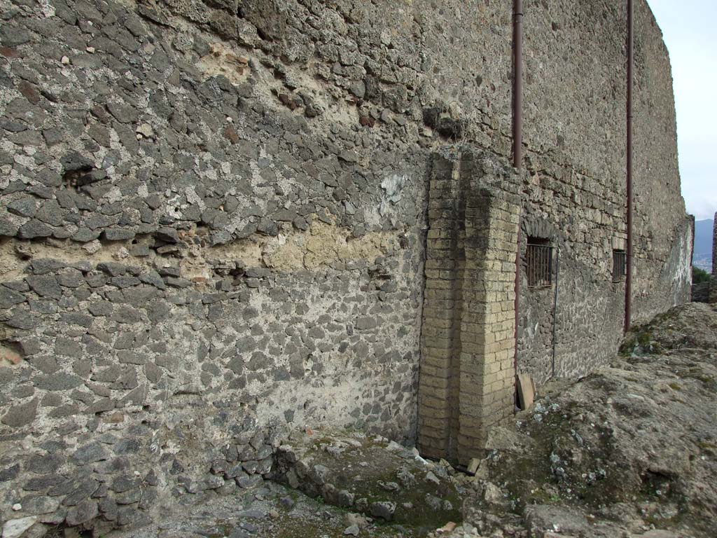 VIII.1.3 Pompeii. March 2009. Road between Basilica and Temple of Venus near VIII.1.5. 
Remains of water supply column against west wall of Basilica.

