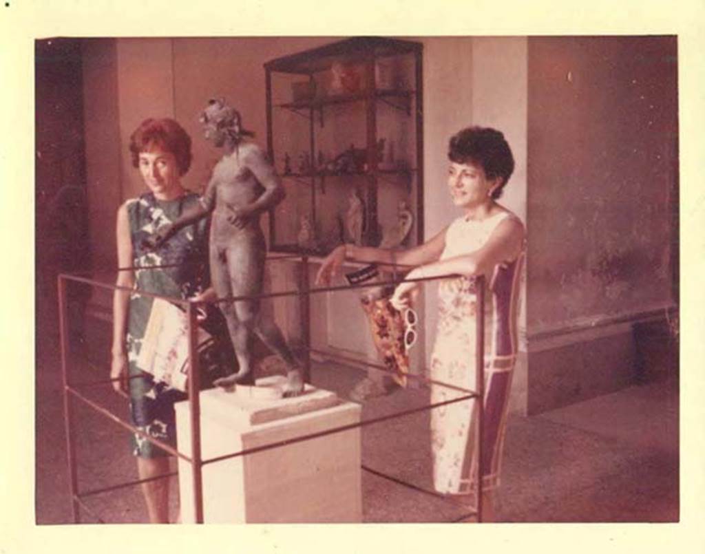 VIII.1.4, Pompeii Antiquarium, July 1964. Bronze statue of Bacchus. Found in I.16.2 on 26th September 1957. Height 0.96m, width 0.37m. 
SAP inventory number 11864. At the rear is a cabinet with small bronze and marble statuettes.
Photo courtesy of Rick Bauer.
