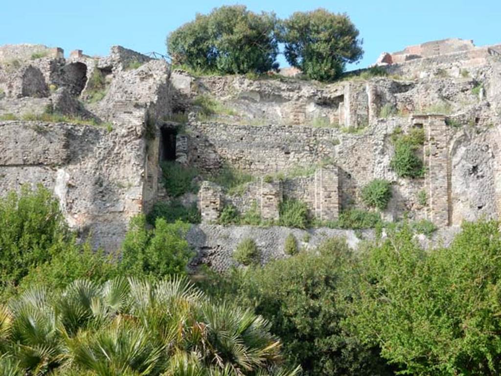 VIII.2.16 Pompeii. May 2015. 
Looking north towards lower floor levels beneath area of collapsed terrace garden. Photo courtesy of Buzz Ferebee.

According to Boyce, in a kind of cave beneath the court located behind the large atrium of number 16, on the extreme edge of the slope was a sacrarium of peculiar nature.
Against the rear wall of a narrow passage was built a masonry seat.
In the wall above it, a vaulted opening led into a small cell hewn out of the rock, with its floor 0.50m below that of the outer passage.
A second masonry seat was built within the cell, back to back with that in the outer passage.
The only means of entrance into this inner chamber appeared to have been over these two seats and through the small opening above them.
Within the cella stood a rectangular masonry altar and upon the altar lay a small terracotta altar, a marble ball, and two lamps decorated with reliefs.
One of the lamps was decorated with the relief of Jupiter, the other of a rose.
See Notizie degli Scavi di Antichit�, 1890, 290.
See Boyce G. K., 1937. Corpus of the Lararia of Pompeii. Rome: MAAR 14. (p.74, no.344) 
See Giacobello, F., 2008. Larari Pompeiani: Iconografia e culto dei Lari in ambito domestico. Milano: LED Edizioni. (p.246)

