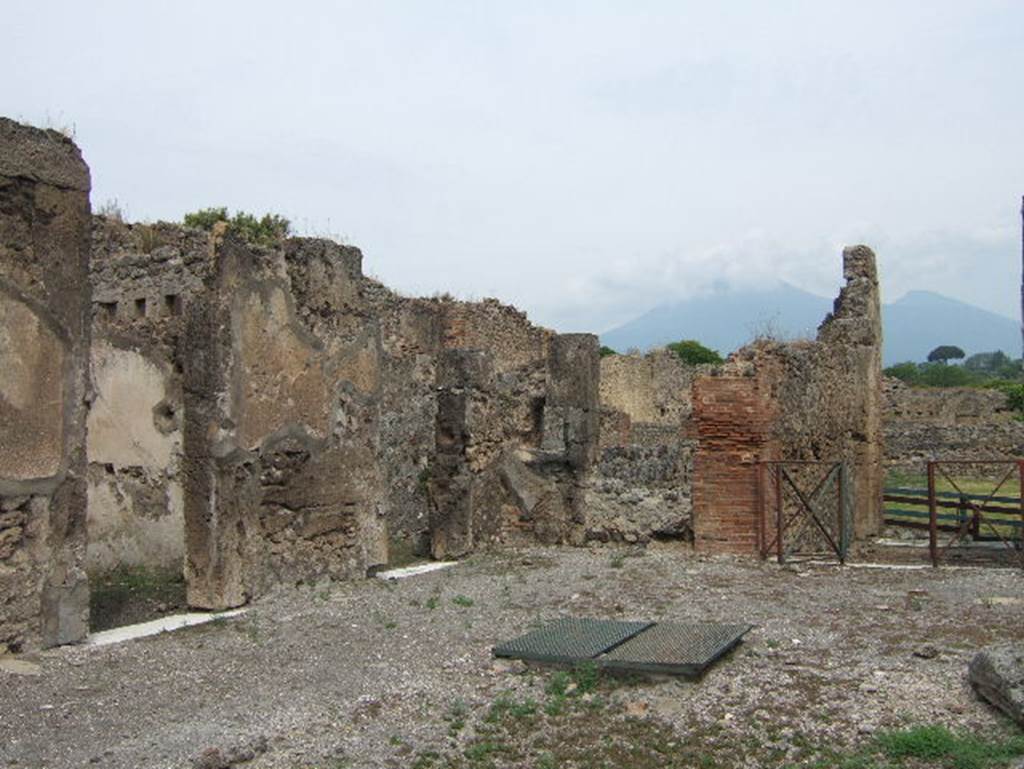 VIII.2.34 Pompeii. May 2006. North-west corner of atrium ‘c’ with doorway to small room ‘L’ and doorway linking to room ‘q’, kitchen area and VIII.2.33.