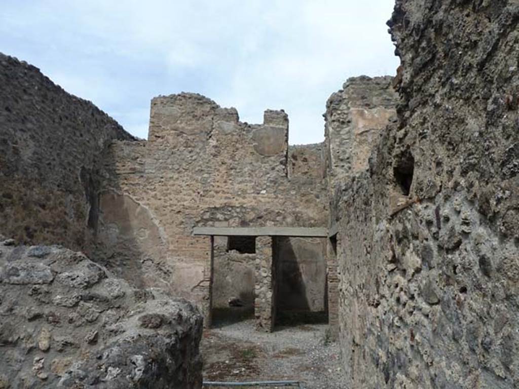 VIII.4.37 Pompeii. September 2015. Looking north from entrance corridor into central courtyard with two doorways in its north wall, and doorway to corridor in the east wall, on right. According to Eschebach, this room was either a small cavaedium (central courtyard) or a sitting room.
See Eschebach, L., 1993. Geb�udeverzeichnis und Stadtplan der antiken Stadt Pompeji. K�ln: B�hlau. (p.376-7)


