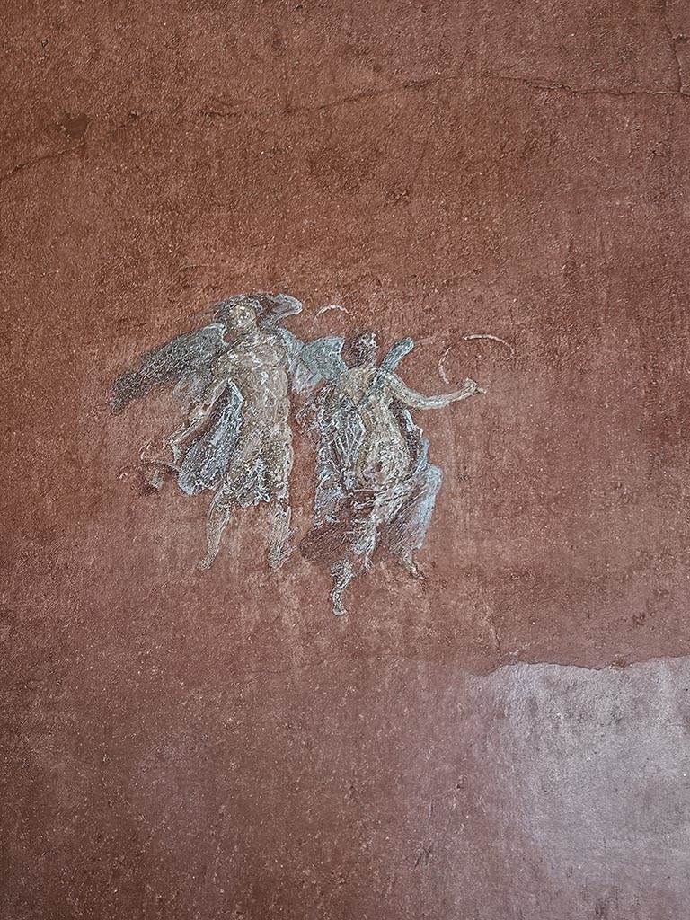VIII.5.37 Pompeii. November 2024.
Room 14, painting of floating figures from south end of west wall of oecus. Photo courtesy of Annette Haug.