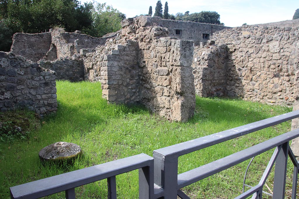 VIII.7.5 Pompeii. October 2024. Looking north-west across workshop to doorway in west wall into rear room, on left.
On the right is the doorway in the north wall. Photo courtesy of Klaus Heese.
