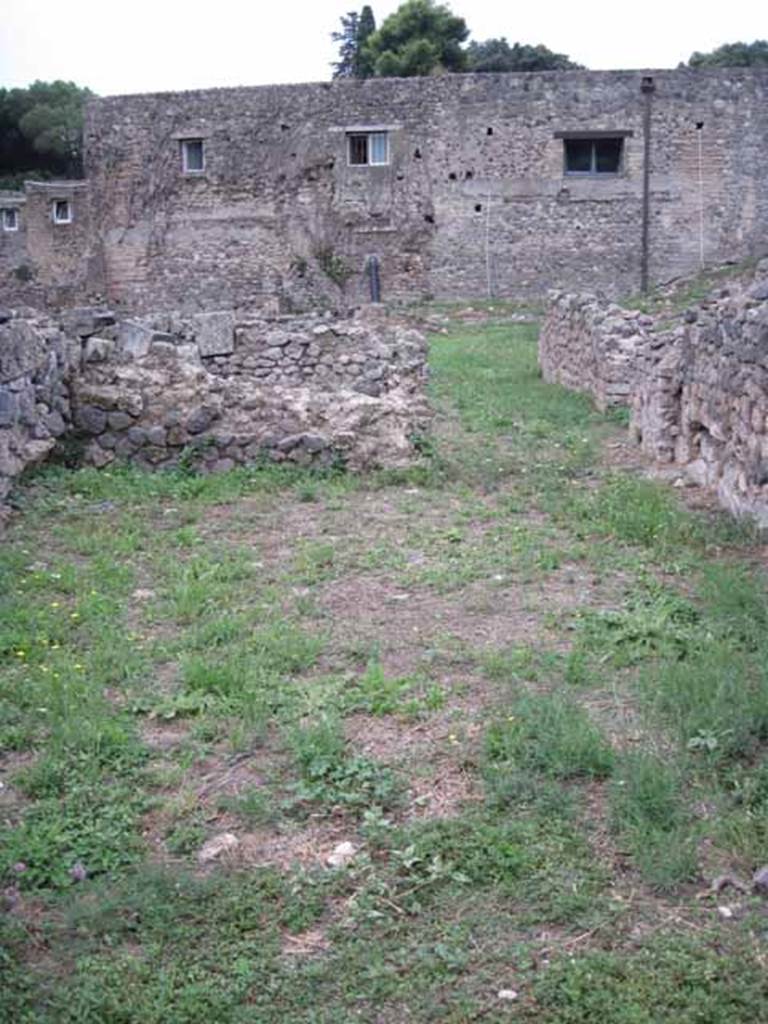 VIII.7.12 Pompeii. September 2010. Looking west across front room of shop towards rear, cubiculum on left, and corridor on right. The 2008 PARP:PS excavation  found remains form several phases of development. These included a tank, a waste chute, a drain and door stops that were located in the centre of the room away from the current threshold. Photo courtesy of Drew Baker.

