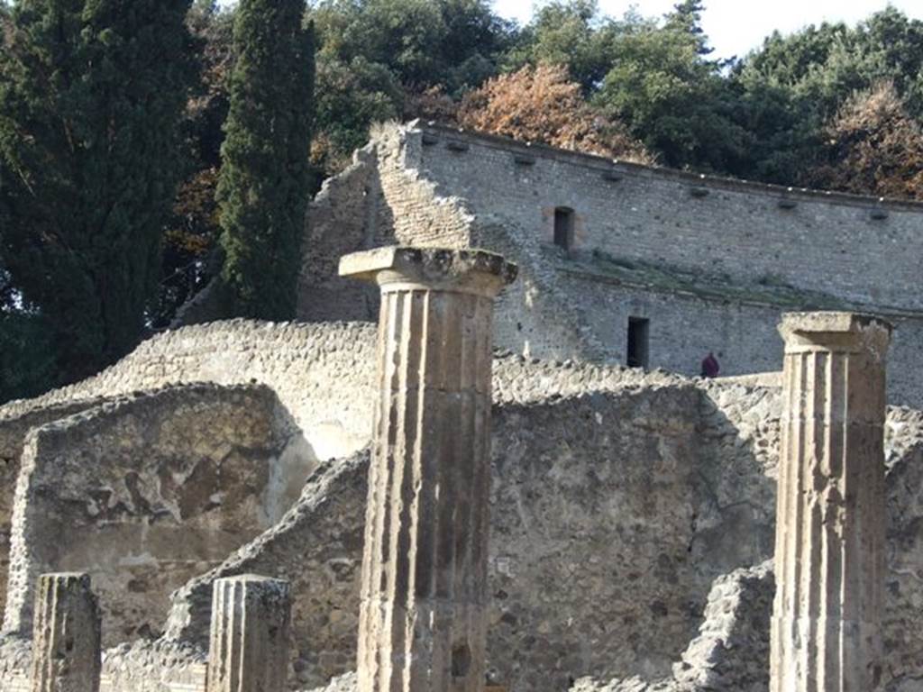 VIII.7.16 Pompeii.  December 2007. Looking over the Doric columns of the colonnade to the walls of the upper storey of the Large Theatre.
