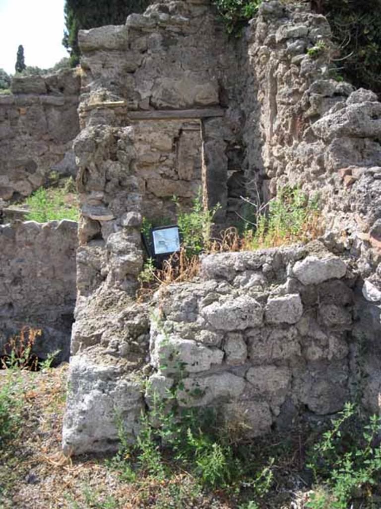 VIII.7.24 Pompeii. September 2010.  North-west corner of northern garden portico looking into VIII.7.26. This shows the small room or cupboard on the east side of the triclinium of VIII.7.26. Photo courtesy of Drew Baker.

