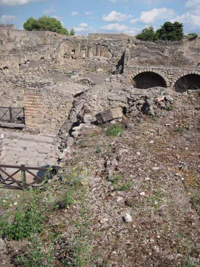 VIII.7.24 Pompeii. September 2010. Edge of collapsed area, looking east across Via Stabiana towards insula I.3. Photo courtesy of Drew Baker.
