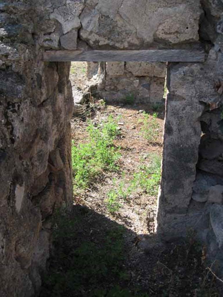 VIII.7.26 Pompeii. September 2010. Looking west from small storeroom or cupboard through doorway into triclinium. Photo courtesy of Drew Baker.