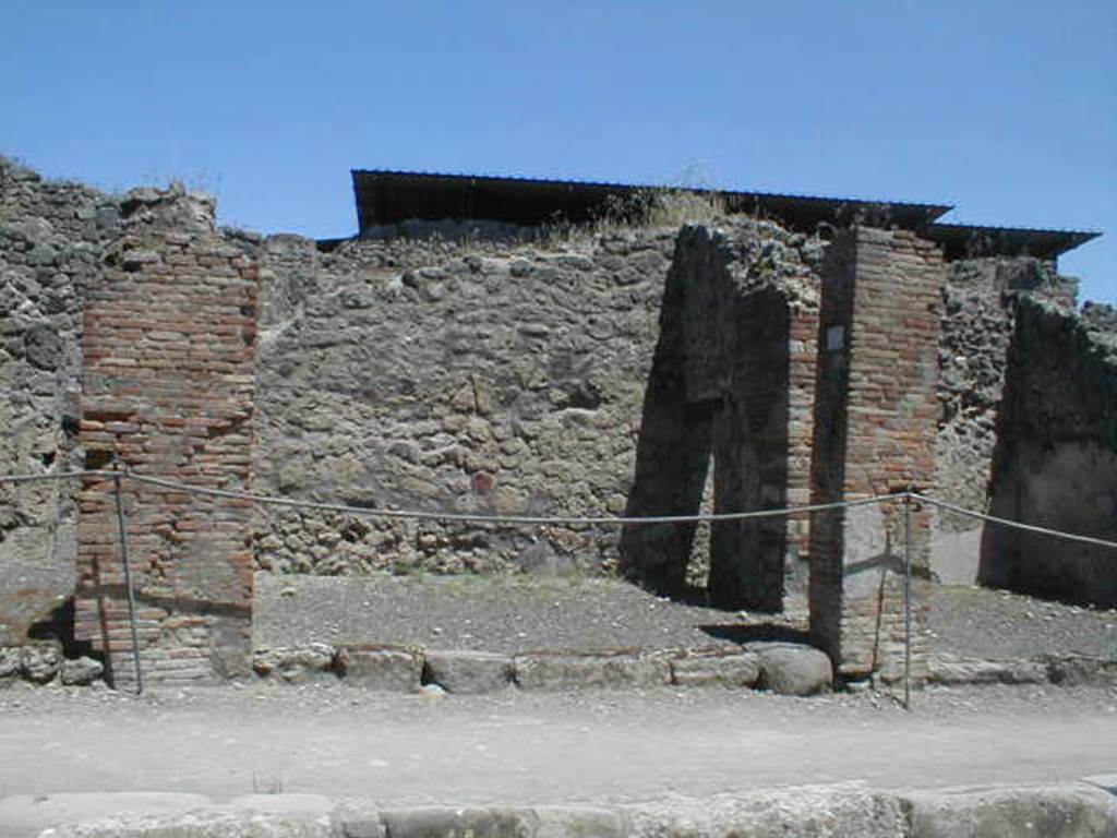 IX.1.10 Pompeii. May 2005. Entrance on Via Stabiana, looking east.
According to Della Corte, found on the pilaster between IX.1.9 or IX.1.10, pilaster on the left, was a painted recommendation, 
Fabritius  rog(at)    [CIL IV 958 ]
He said he could not know which of the two shops this Pompeian was established in.
See Della Corte, M., 1965.  Case ed Abitanti di Pompei. Napoli: Fausto Fiorentino. (p.210).
According to Pagano and Prisciandaro, the graffiti in black was found at IX.1.11 in July 1853.  This was probably the pilaster on the right between IX.1.10 and IX.1.11, and read:
Faustinum aed(ilem)
Fabritius rog(at)  [CIL IV 958]
See Pagano, M. and Prisciandaro, R., 2006. Studio sulle provenienze degli oggetti rinvenuti negli scavi borbonici del regno di Napoli. Naples : Nicola Longobardi. (p.169)
For the list of bronze, iron,terracotta, glass, bone and amphorae found in this shop,
See Gallo, A (2001). Pompei, L�Insula I della Regione IX, Settore Occidentale (p.61), in SAP book no. 1 (L�Erma di Bretschneider)
