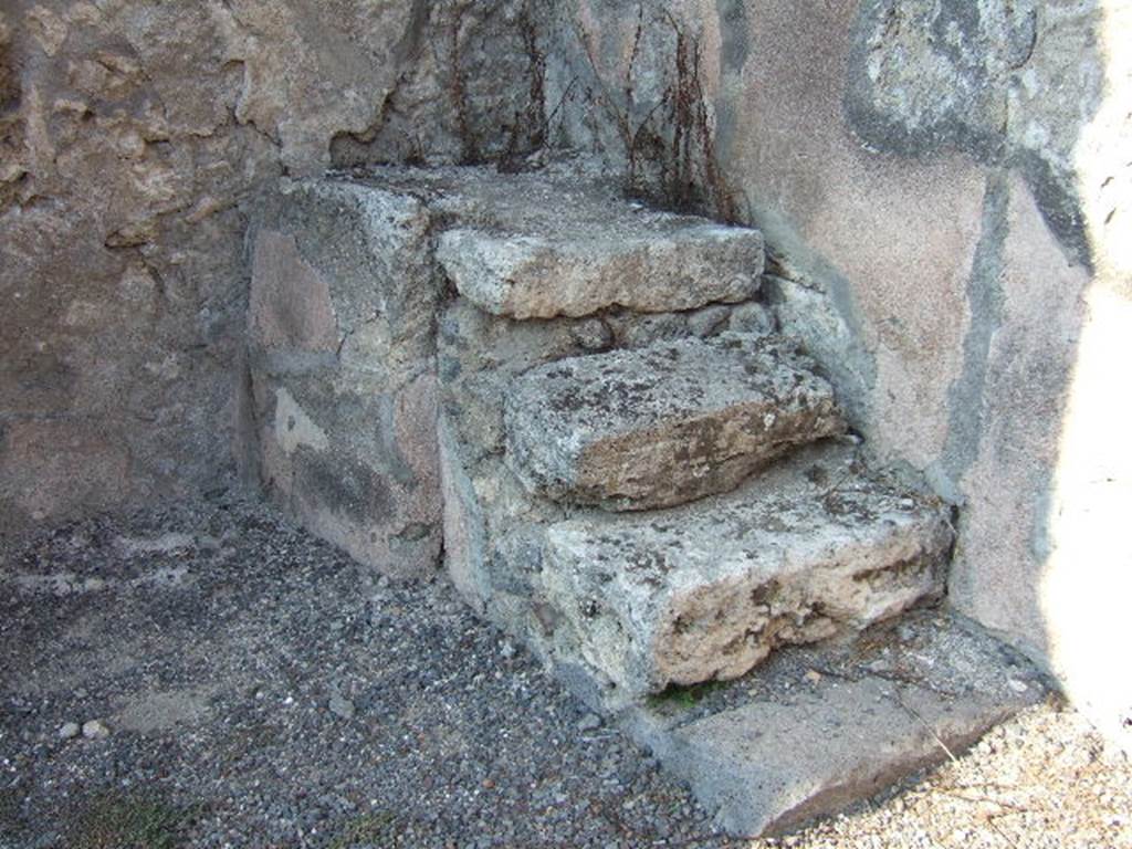 IX.2.9 Pompeii. September 2005. Stone steps to upper floor in north-east corner of rear room. The upper part of the stairs would have continued in wood. 
