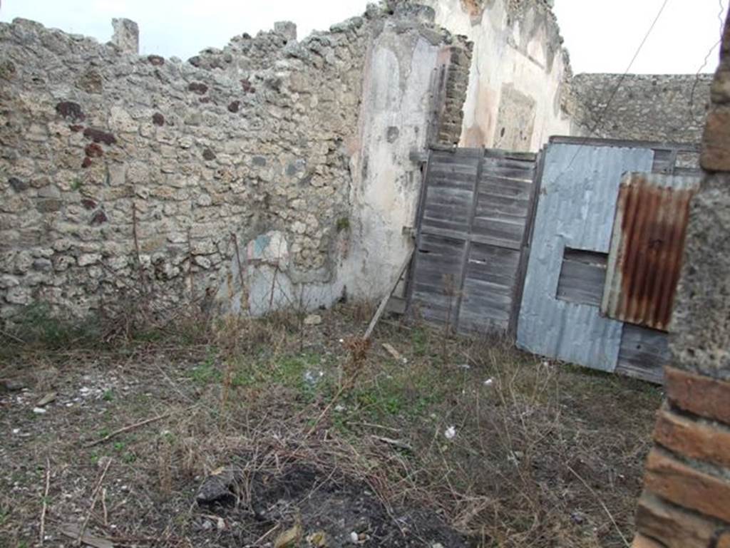 IX.2.16 Pompeii. December 2007. Tablinum, looking east. According to Bragantini, the floor would have been of lavapesto with marble insets. The wall dado would have been white, panelled with compartments of painted plants. The middle zone of the walls would have been red. The red north wall showed divisions painted in azure blue. The east wall was red. The south wall was panelled in red. The central panel contained the painting of the Three Graces. The side panels had vignettes, but they had faded. The panels were separated by painted candelabra at the base of the blue divisions. The upper zone had faded, but architectural designs would have been seen there. The west wall had red panels with borders of azure blue, with a faded vignette. The upper zone was red.
See Bragantini, de Vos, Badoni, 1986. Pitture e Pavimenti di Pompei, Parte 3. Rome: ICCD. (p.416, tablino ‘k’)
According to Sogliano, other paintings found in the tablinum were –
Head of a young Satyr, on a white background (p.42, no.183)
Young Satyr and Old Satyr (2 paintings), both on white background (p.43, nos.188/189)
A Bacchante with bacchic attributes, on a white background (p.47, no.211)
A flying Cupid (p.57, no.298)
Flying Psyches (5 paintings) (p.66, nos.383/4/5/6/7)
See Sogliano, A., 1879. Le pitture murali campane scoverte negli anni 1867-79. Napoli: Giannini. 
See BdI, 1871, p.200-204
