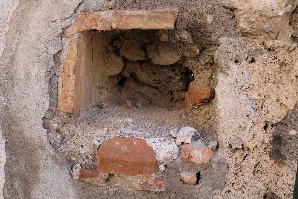 IX.2.21 Pompeii. December 2018. 
West side of entrance doorway, possible niche, or as described by Warscher �a hole for barring the door�. Photo courtesy of Aude Durand.

