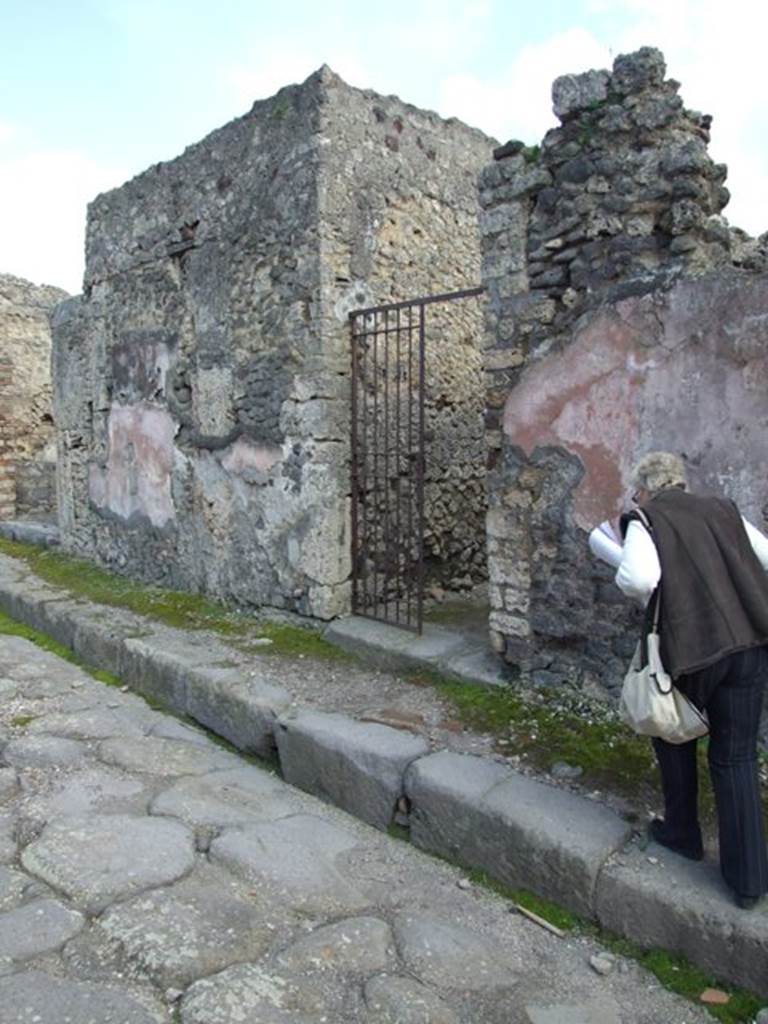 IX.2.26  Pompeii. March 2009. Entrance doorway in façade. The two coloured painted panels of the plaster can just about be seen.



