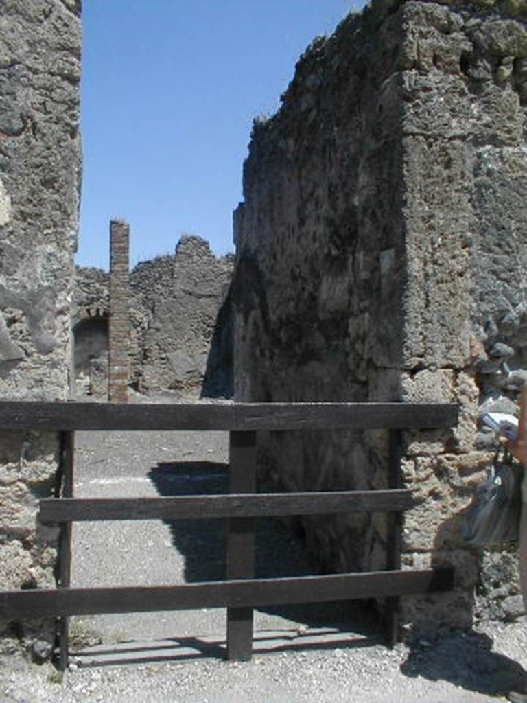 IX.3.2 Pompeii. May 2005. Entrance.  According to Mau, the election notice found on the outside wall   Postumium  Proculum  aed.  Offectores  rog(ant)   [CIL IV 864]   (The Dyers request the election of Postumius Proculus as aedile)  may have indicated that the Dyers of the two establishments opposite each other, IX.3.2 and VII.2.11, had united in supporting the candidacy of Proculus.
See Mau, A., 1907, translated by Kelsey F. W. Pompeii: Its Life and Art. New York: Macmillan. (p.386)

Found in September 1843, graffiti on the pilaster on the left, between IX.3.1 and IX.3.2 
M(arcum)  Holconium
Priscum  aedil(em)  o(ro)  v(os)  f(aciatis)    [CIL IV 860]

Graffiti on the pilaster on the right, between IX.3.2 and IX.3.3 read
Q(uintum)  Postumium
aed(ilem)    [CIL IV 861]

Casellium    [CIL IV 862]

M(arcum)  Holconium
Priscum  aedil(em)  o(ro)  v(os)  f(aciatis)    [CIL IV 863]

See Pagano M. and Prisciandaro, R., 2006. Studio sulle provenienze degli oggetti rinvenuti negli scavi borbonici del regno di Napoli.  Naples : Nicola Longobardi.  (p.159)
