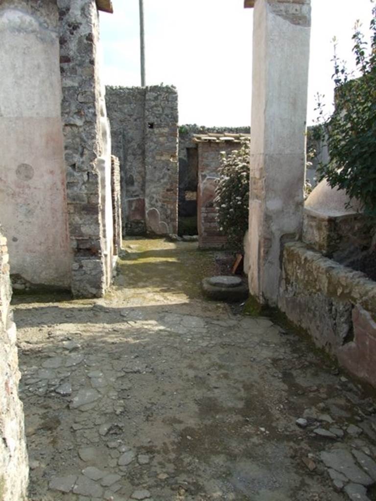 IX.3.5 Pompeii. March 2009. Room 21, corridor, looking south. Large doorway to room 20, on left.  According to Dyer: �The peristyle is surrounded on two of its sides with square columns, painted with plants on a red background. The pillars are connected together by a low wall, which leaves two openings into the xystus, or garden. On the other sides it is bounded by the tablinum in front, and by an exedra or oecus, on the right (of the peristyle)�.
See Dyer, T., 1867. The Ruins of Pompeii. London: Bell and Daldy. (p.85)
