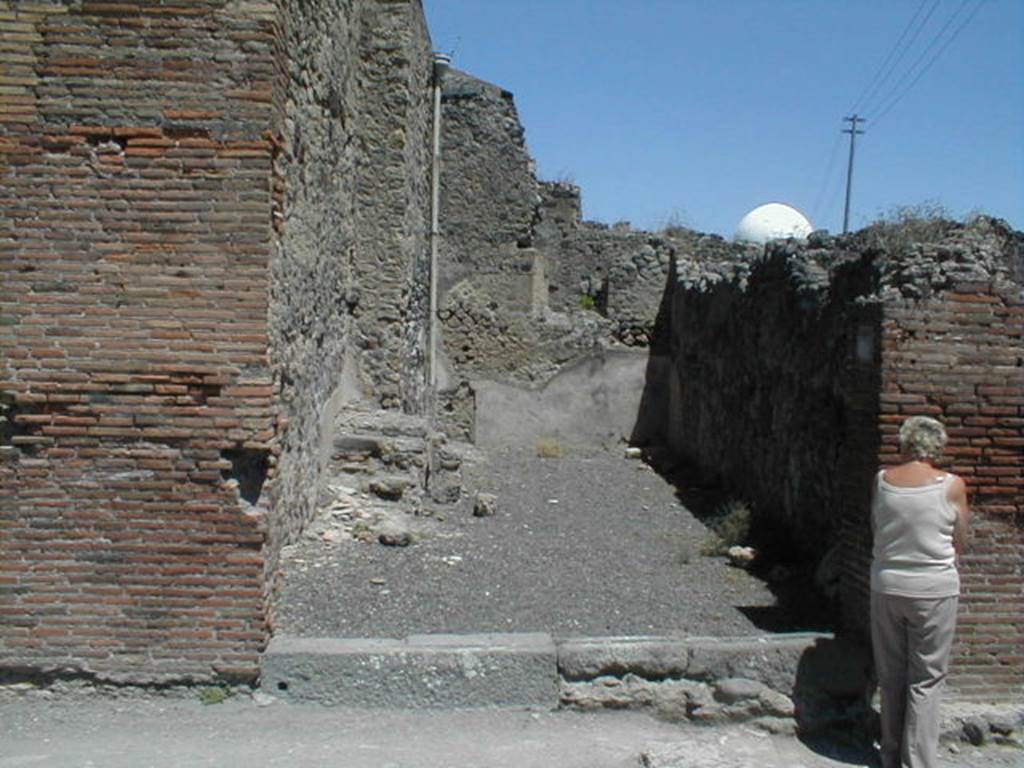 IX.3.7 Pompeii. May 2005. Entrance, looking east from Via Stabiana.
According to Fiorelli, �this shop was very deep, and inside had stairs to the mezzanine above with the niche of the Penates, near to which was found that painting depicting Isis-Fortuna on the globe, the god Luno on horseback, and winged Esperus carrying a torch: at the top one read� -
 
See Fiorelli, G., (1875). Descrizione di Pompei, (p.394)
See Pappalardo, U., 2001. La Descrizione di Pompei per Giuseppe Fiorelli (1875). Napoli: Massa Editore. (p.146)
See Bullettino dell�Instituto di Corrispondenza Archeologica (DAIR), 1847, p. 127-8.

