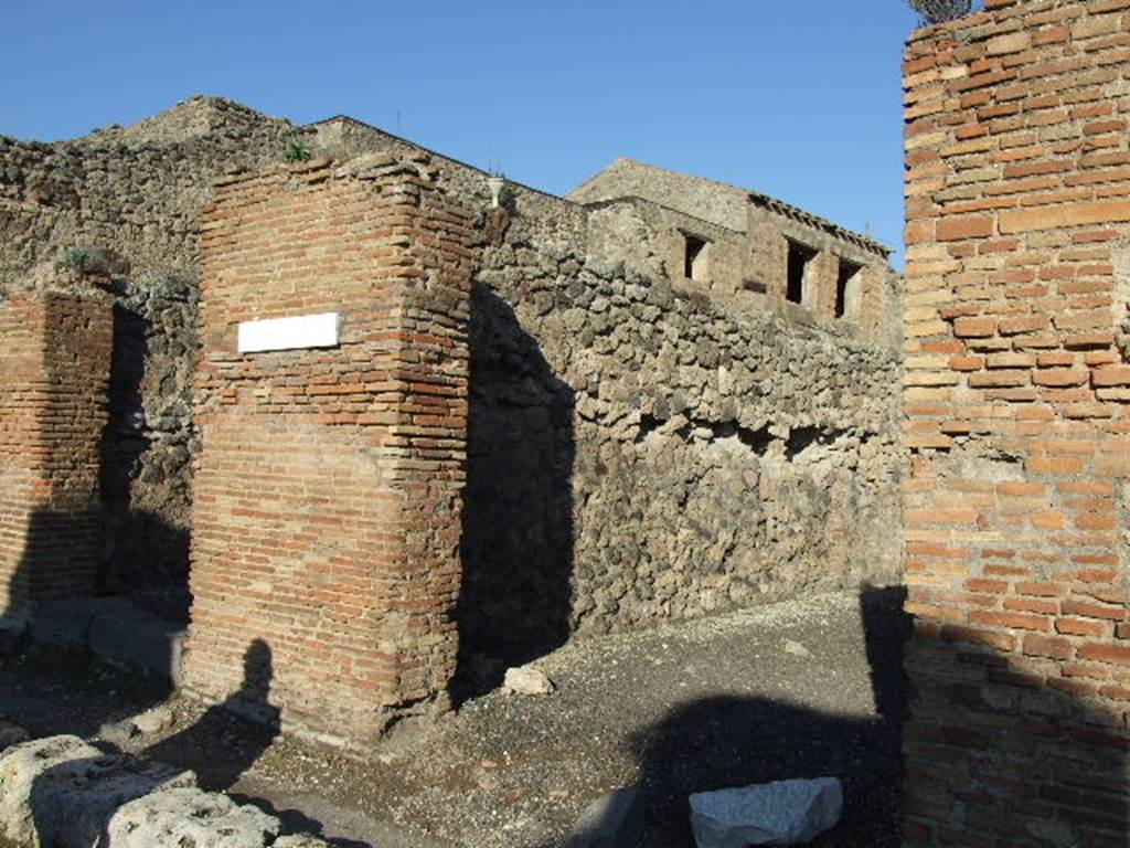 IX.3.9 Pompeii. December 2007. Entrance, looking towards north wall.
On the pilaster that separates these two shops, on the left between IX.3.8 and 9, a mutilated graffiti was found   
Titus ? �  rog(at)   [CIL IV 884]
See Della Corte, M., 1965.  Case ed Abitanti di Pompei. Napoli: Fausto Fiorentino. (p.162)
According to Della Corte, also found on this pilaster on the left, was the graffiti
Multum  pistores  rogant     [CIL IV 886]  
This graffiti was written in support of the candidate Giulio Polibio  (see IX.3.8).
See Della Corte, M., 1965.  Case ed Abitanti di Pompei. Napoli: Fausto Fiorentino. (p. 159)
