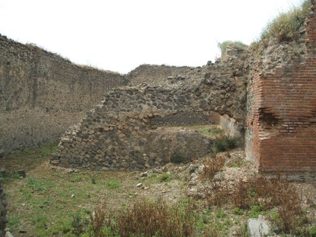 IX.4.15 Pompeii. May 2005. L shaped service area �t� with small garden. Looking west from entrance towards south-east corner of caldarium, and remains of garden wall. According to Jashemski, the five small windows of the caldarium looked out onto a small garden. The garden would have had a wall enclosing it, to hide from view the men walking back and forth tending the furnaces. The wall was only partially completed. See Jashemski, W. F., 1993. The Gardens of Pompeii, Volume II: Appendices. New York: Caratzas. (p.235).