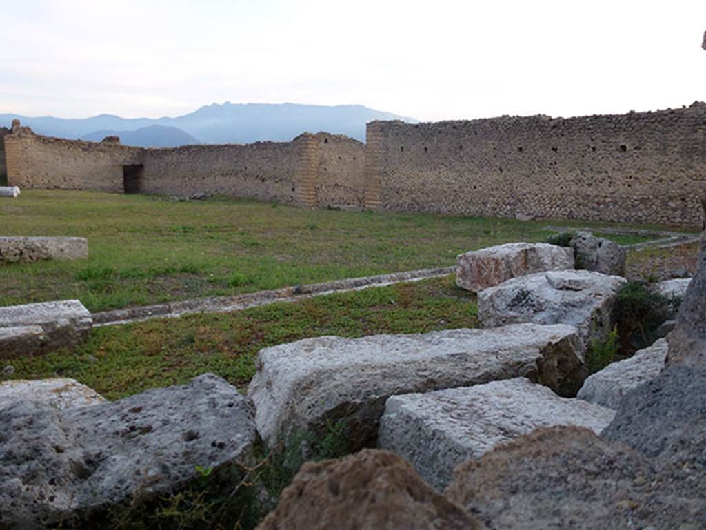 IX.4.18 Pompeii. September 2011. West wall of baths. Looking south-west across palaestra “d” from the entrance on Via di Nola. The wide entrance in the centre of the west wall of the baths is IX.4.5, on Via Stabiana. The smaller darker entrance on the south side, in the south-west corner is IX.4.10, on an unnamed vicolo. Photo courtesy of Michael Binns.